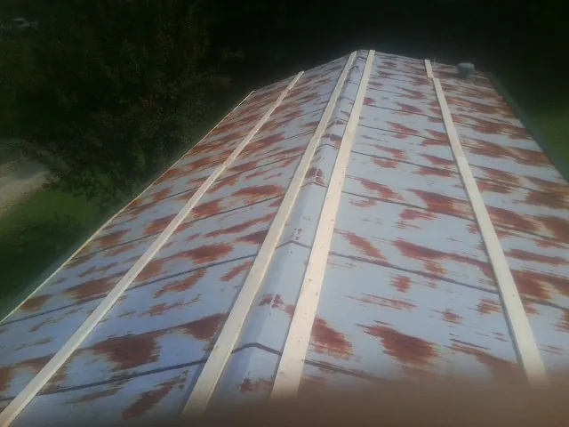 Rusted metal roof panels with new wood purlins before replacement — Storm Damage Roof Repair in Hopatcong by Roofing Brothers