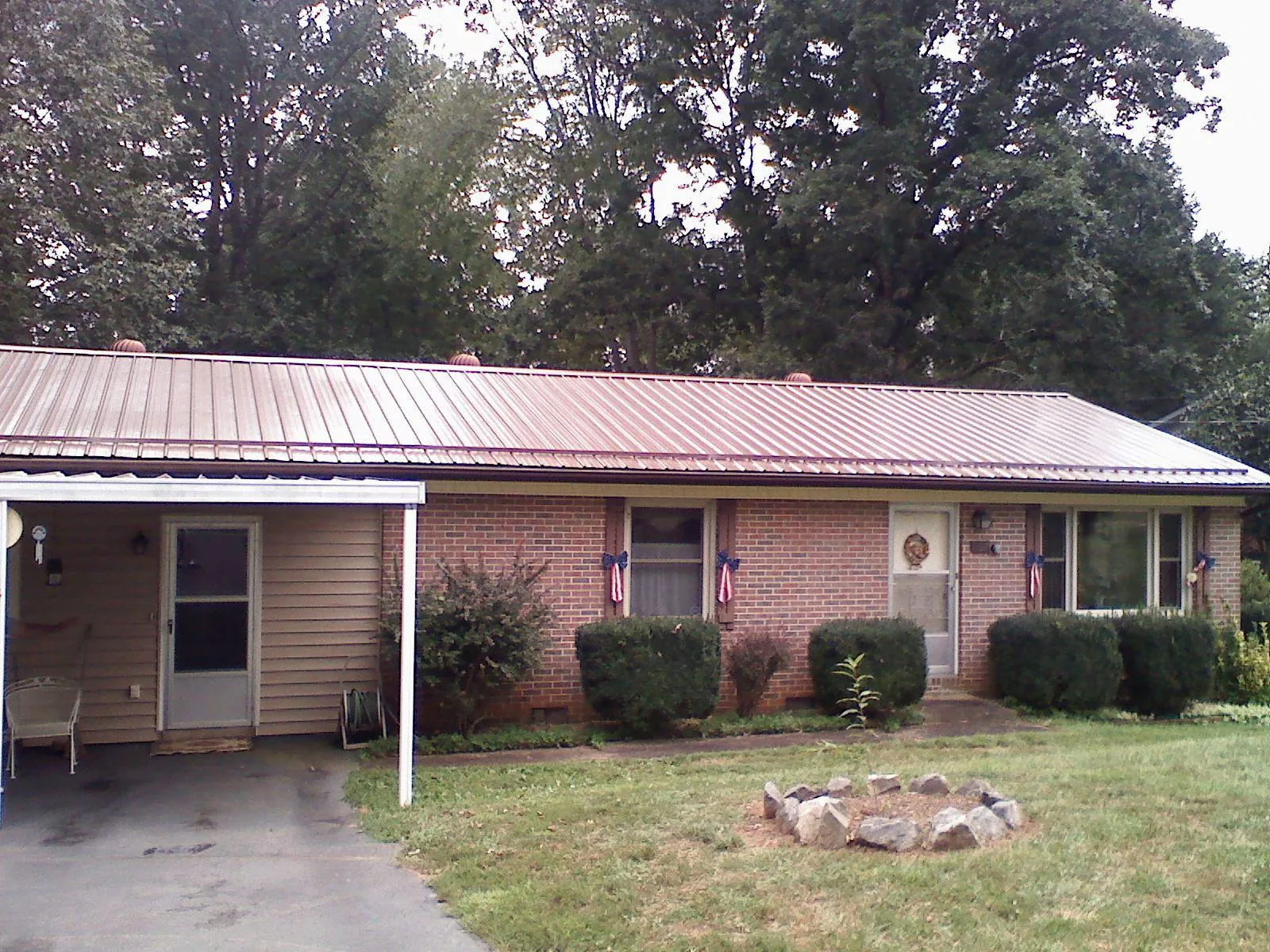 Bronze metal roof and carport on a brick ranch home — Roof Repair work by our crew in Hopatcong